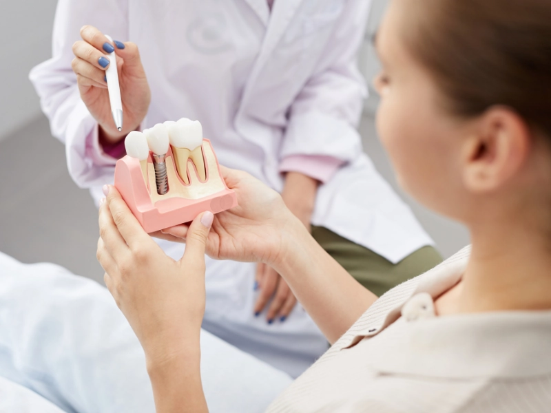 patient being shown a dental implant in anchorage, ak