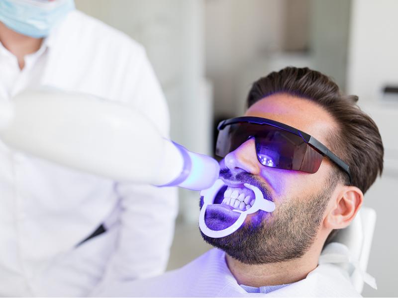 A patient getting in-office teeth whitening in Anchorage, AK